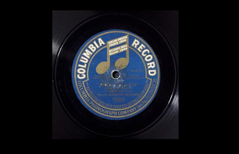 A photograph of a vinyl record with the blue label with a hold musical note and white text that reads: Columbia Records