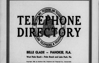 A black and white page within a telephone directory with the title Telephone Directory and four advertisements above and below the title